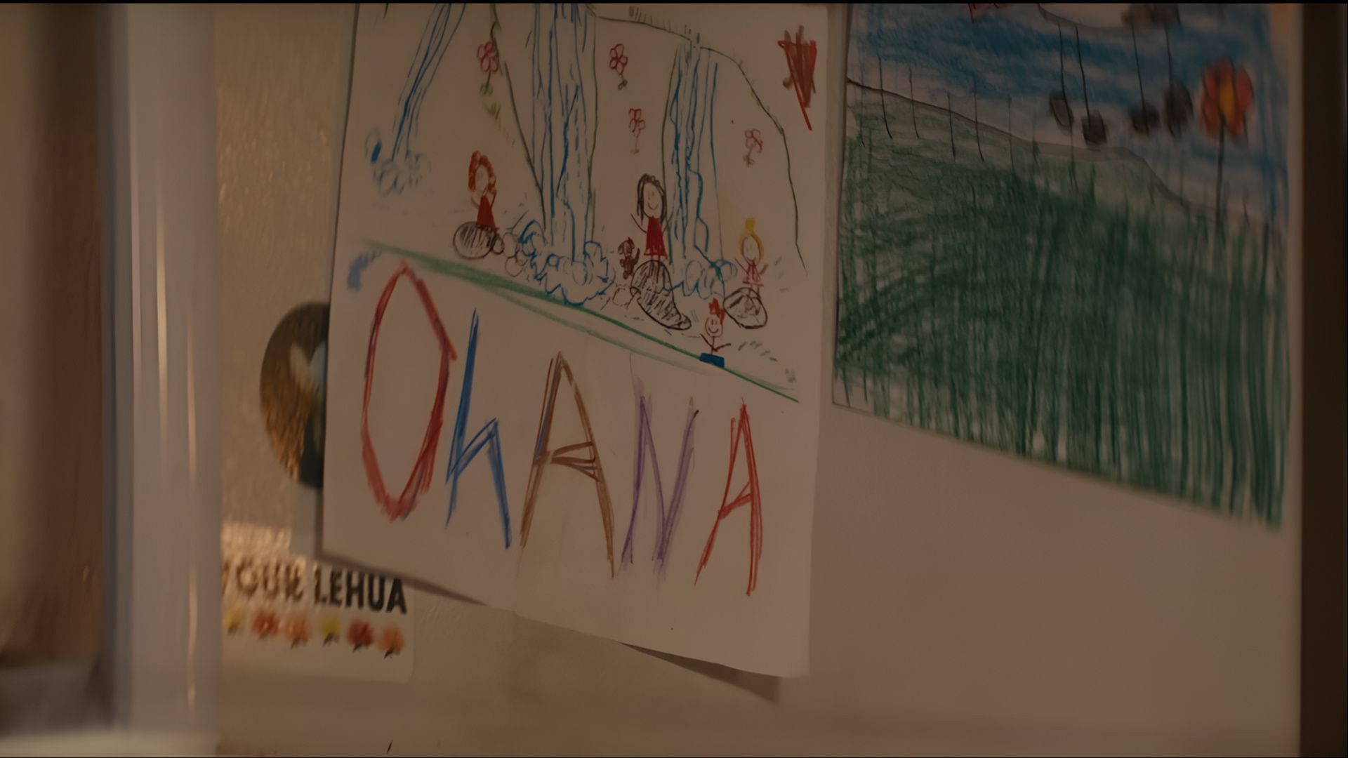 Lilo’s drawing of “Ohana” reinforces the central theme of family in Disney’s live-action Lilo & Stitch. (Image via Disney)